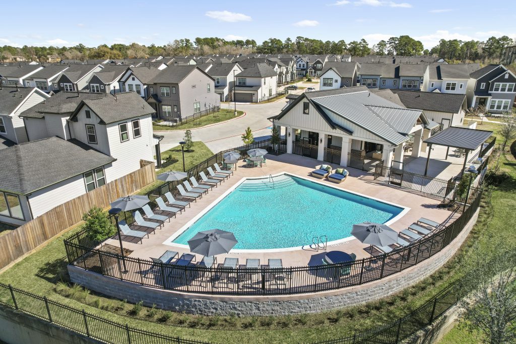 A swimming pool surrounded by build-to-rent homes